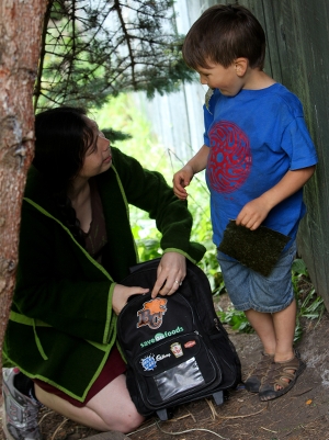 a teacher at Oak and Orca School get's down to the child's height